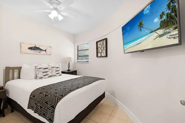 a bedroom with a bed and a painting on the wall