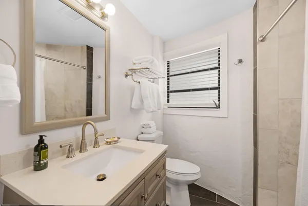 a bathroom with a shower and a sink