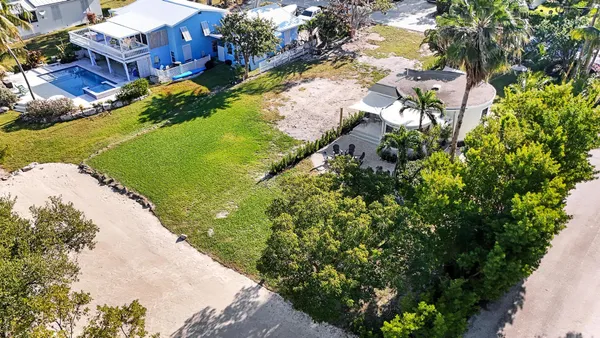 an aerial view of a house with a yard basket ball court