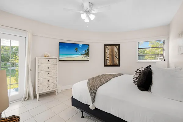 a bedroom with a bed and a lamp with the dresser