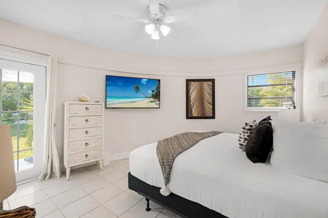 a bedroom with a bed and a lamp with the dresser