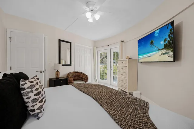 a spacious bedroom with a bed and a chandelier