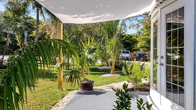 a view of a house with a tree and yard