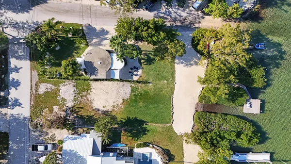 an aerial view of a house with a yard basket ball court and outdoor seating