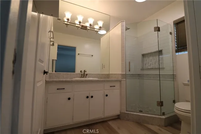 a bathroom with a double vanity sink toilet and shower