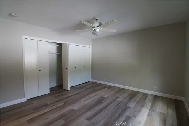 an empty room with wooden floor and door