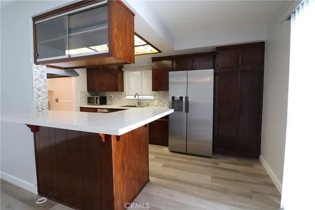 a kitchen with stainless steel appliances a sink and a refrigerator