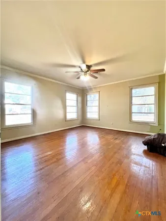 a view of a livingroom with wooden floor and window