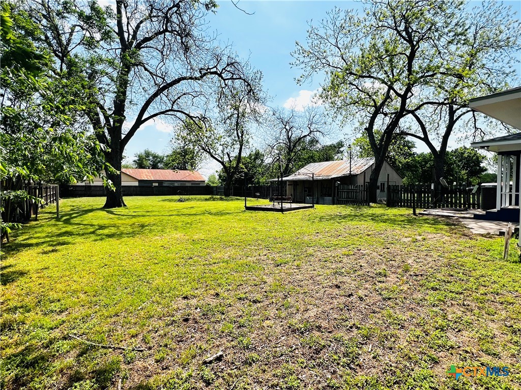 1307 West Main Street Cameron, TX 76520 - Photo 6 of 24 a view of a swimming pool with an outdoor space and seating area