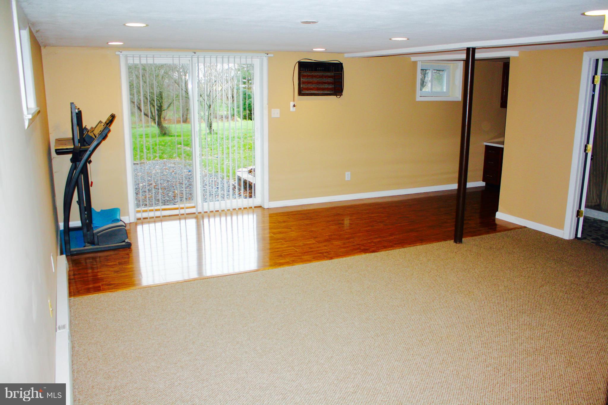 28400 Clarksburg Road Damascus, MD 20872 - Photo 14 of 16 a view of an empty room with wooden floor and a window