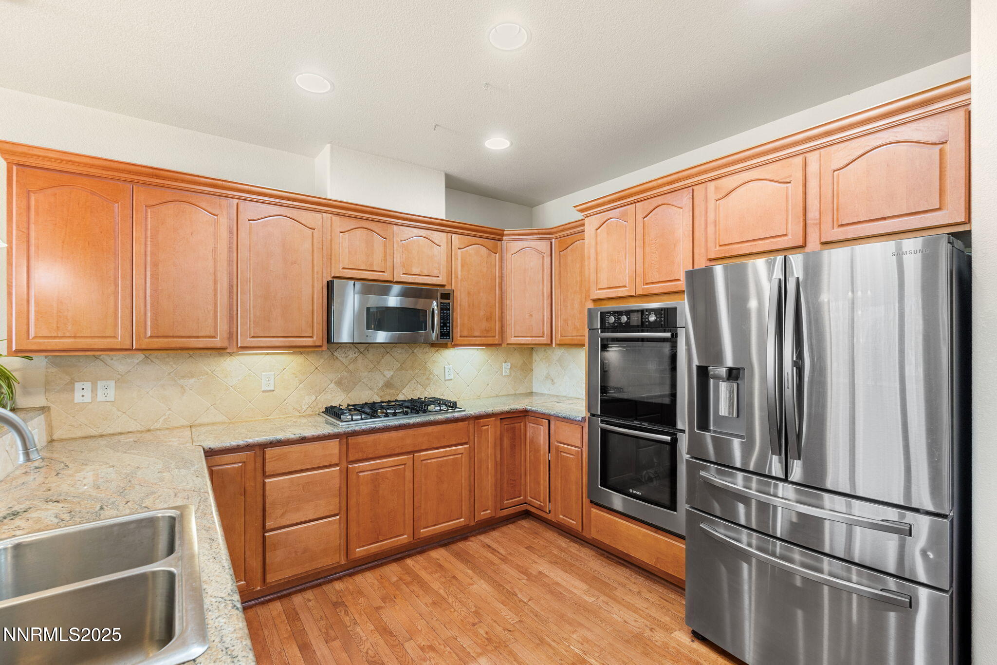 306 San Roma Drive Dayton, NV 89403 - Photo 20 of 46 a kitchen with granite countertop stainless steel appliances a refrigerator sink and microwave