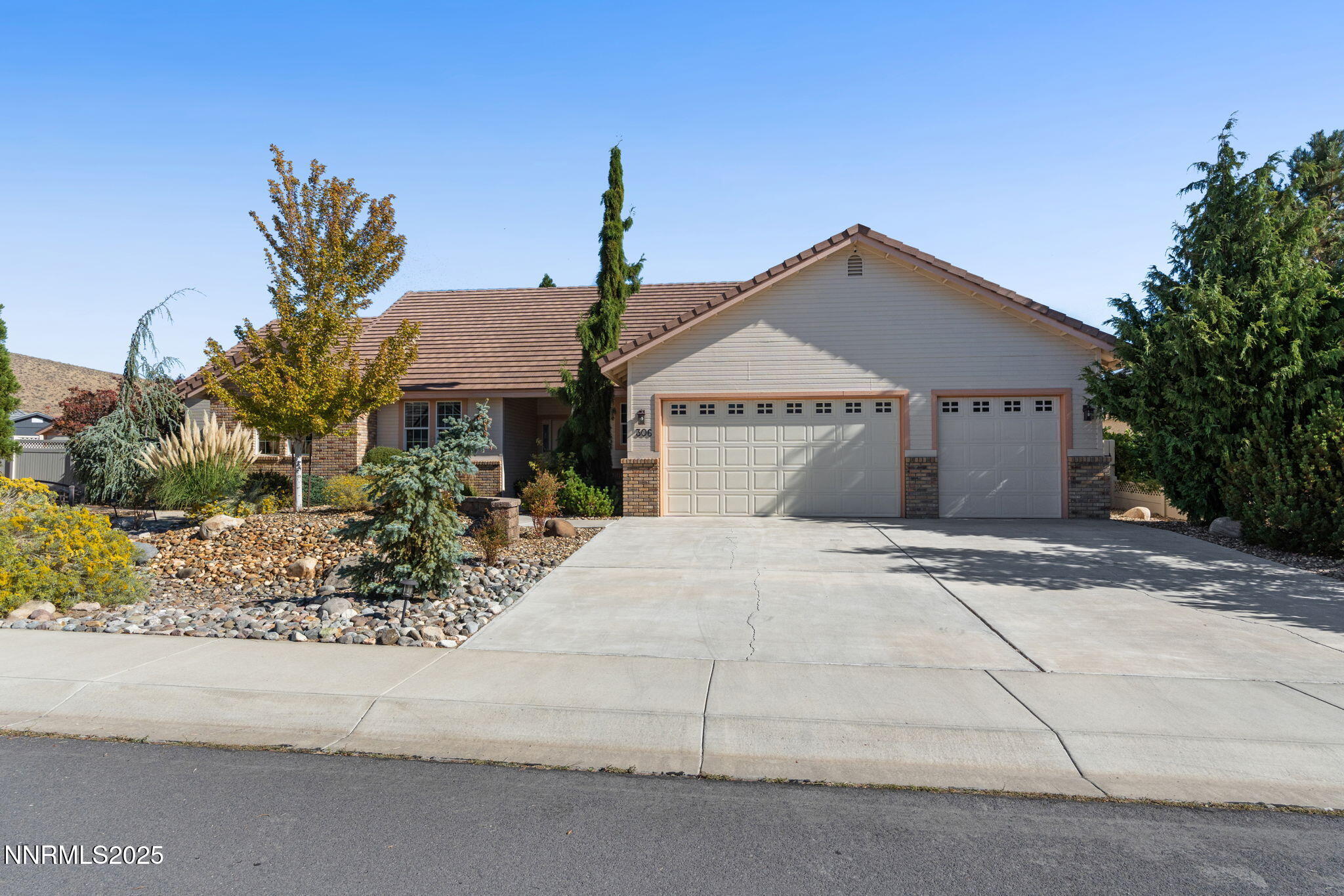 306 San Roma Drive Dayton, NV 89403 - Photo 2 of 46 a front view of a house with a yard and garage
