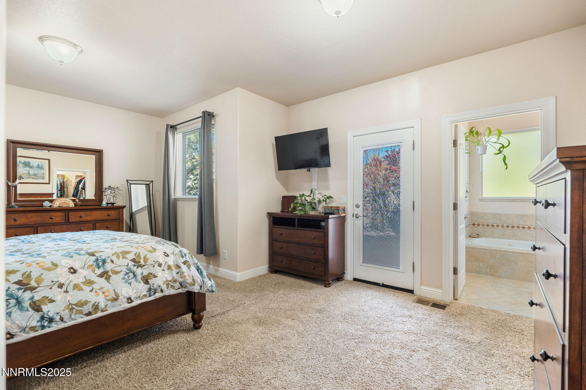 306 San Roma Drive Dayton, NV 89403 - Photo 25 of 46 a bedroom with a bed and a flat screen tv