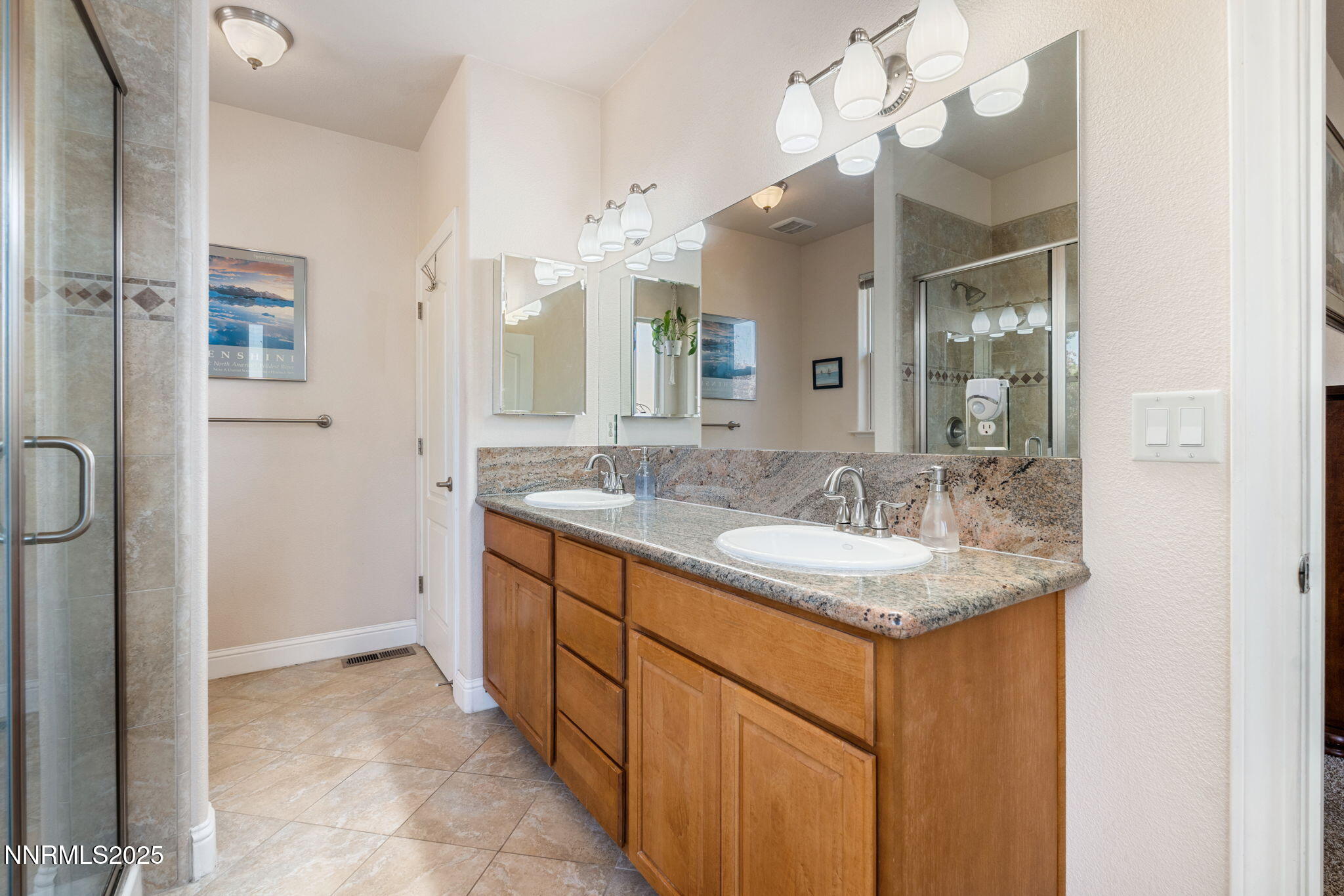 306 San Roma Drive Dayton, NV 89403 - Photo 26 of 46 a bathroom with a granite countertop sink a large mirror and a shower