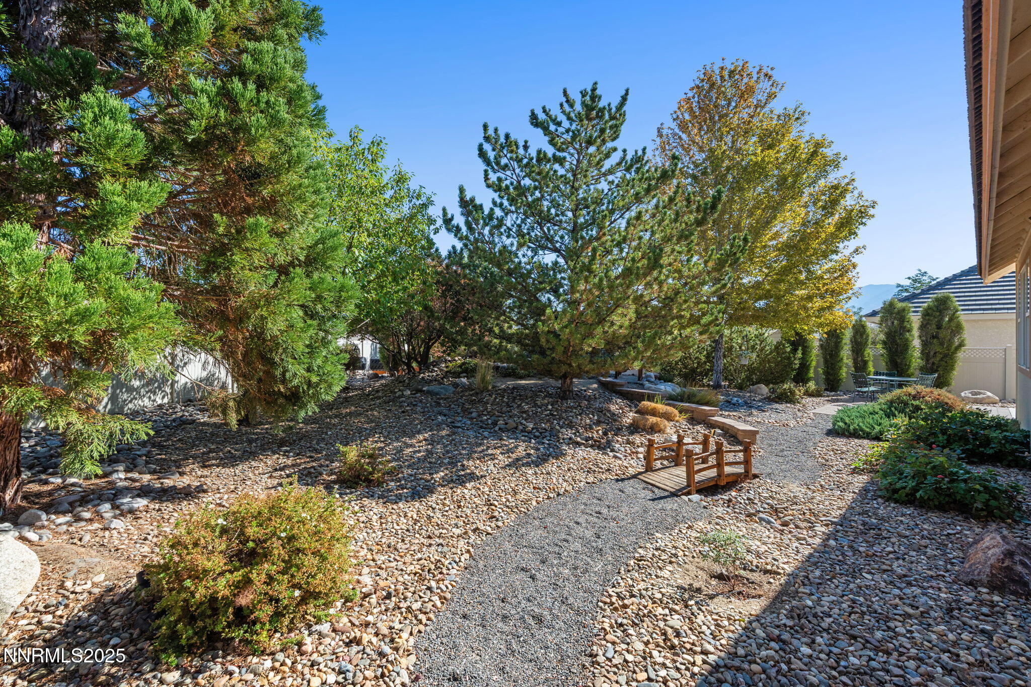 306 San Roma Drive Dayton, NV 89403 - Photo 43 of 46 a view of a backyard with chairs potted plants and large trees