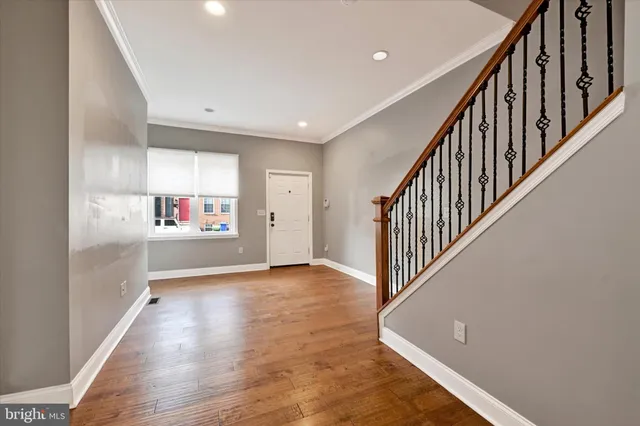 a view of an entryway with wooden floor
