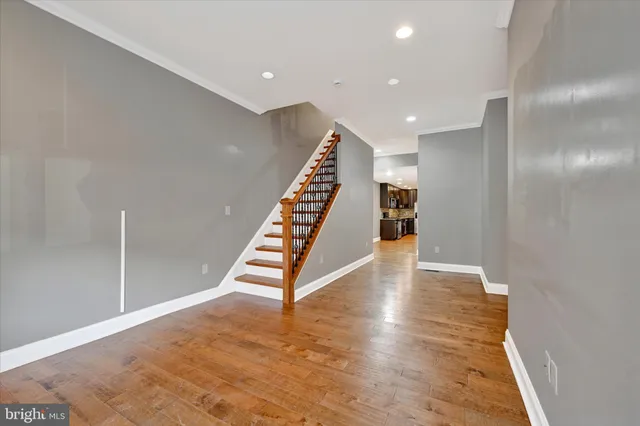 a view of an empty room with wooden floor