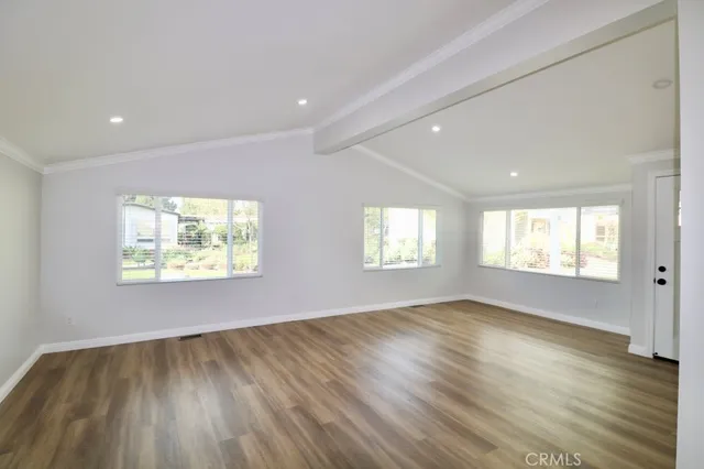 a view of an empty room and a window