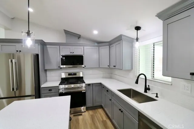 a kitchen with sink a stove and refrigerator