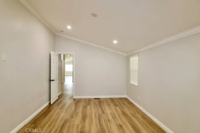 a view of room with window and wooden floor