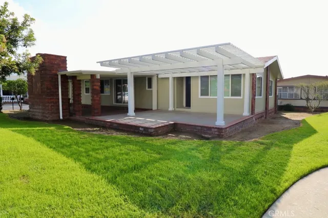 a view of a house with a yard and sitting area