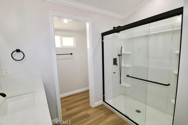 a bathroom with a glass shower door
