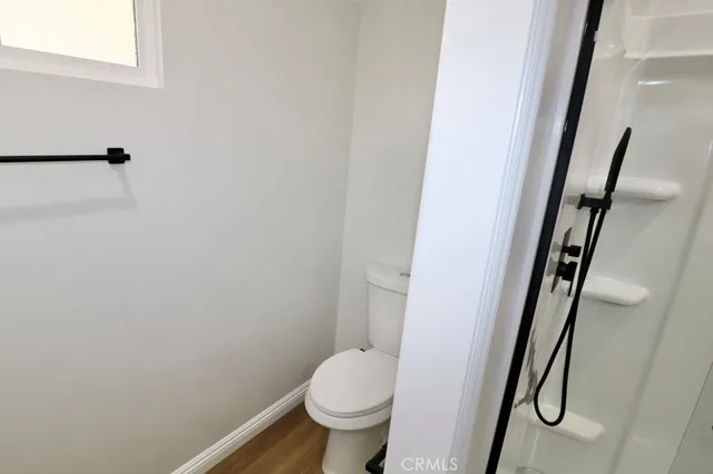 a bathroom with a granite countertop toilet and a sink