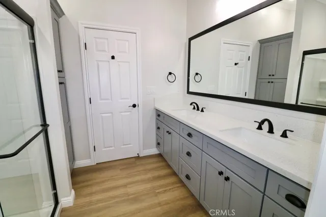 a bathroom with double vanity sink and mirror