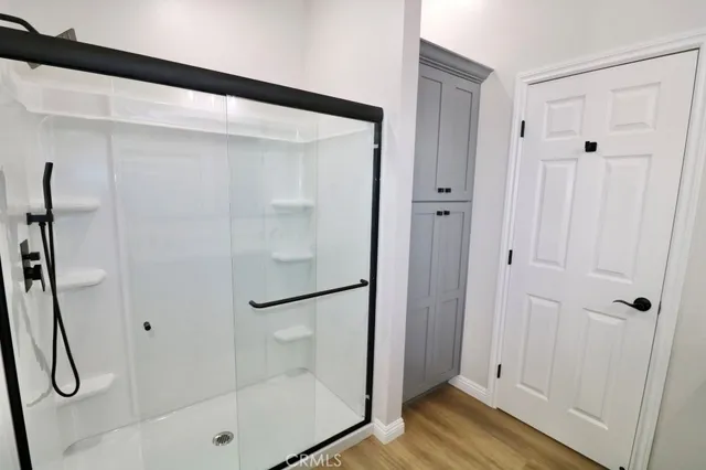 a bathroom with a glass shower door