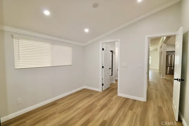 a view of a room with wooden floor and a bathroom