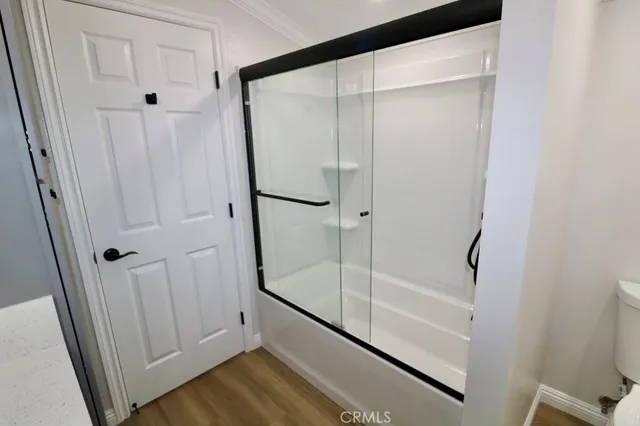 a bathroom with a glass shower door and a sink
