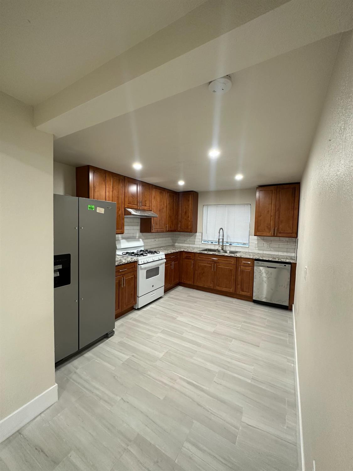 a large kitchen with stainless steel appliances kitchen island a large counter top oven and cabinets