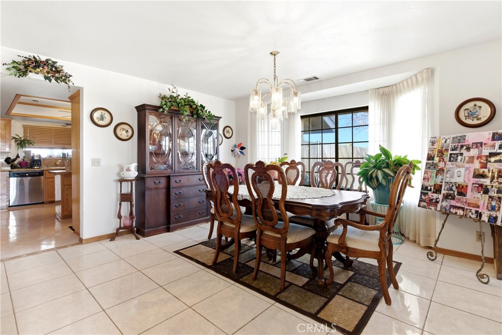11468 Kiowa Road Apple Valley, CA 92308 - Photo 16 of 73 a view of a dining room with furniture and chandelier