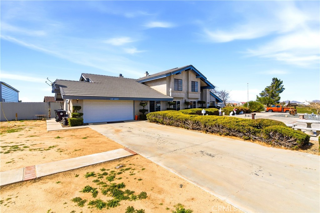 11468 Kiowa Road Apple Valley, CA 92308 - Photo 2 of 73 a front view of a house with a yard