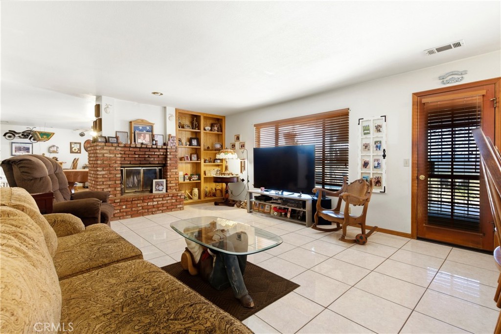 11468 Kiowa Road Apple Valley, CA 92308 - Photo 32 of 73 a living room with furniture and a flat screen tv