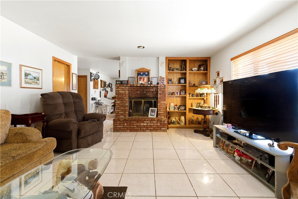 11468 Kiowa Road Apple Valley, CA 92308 - Photo 33 of 73 a living room with furniture and a flat screen tv