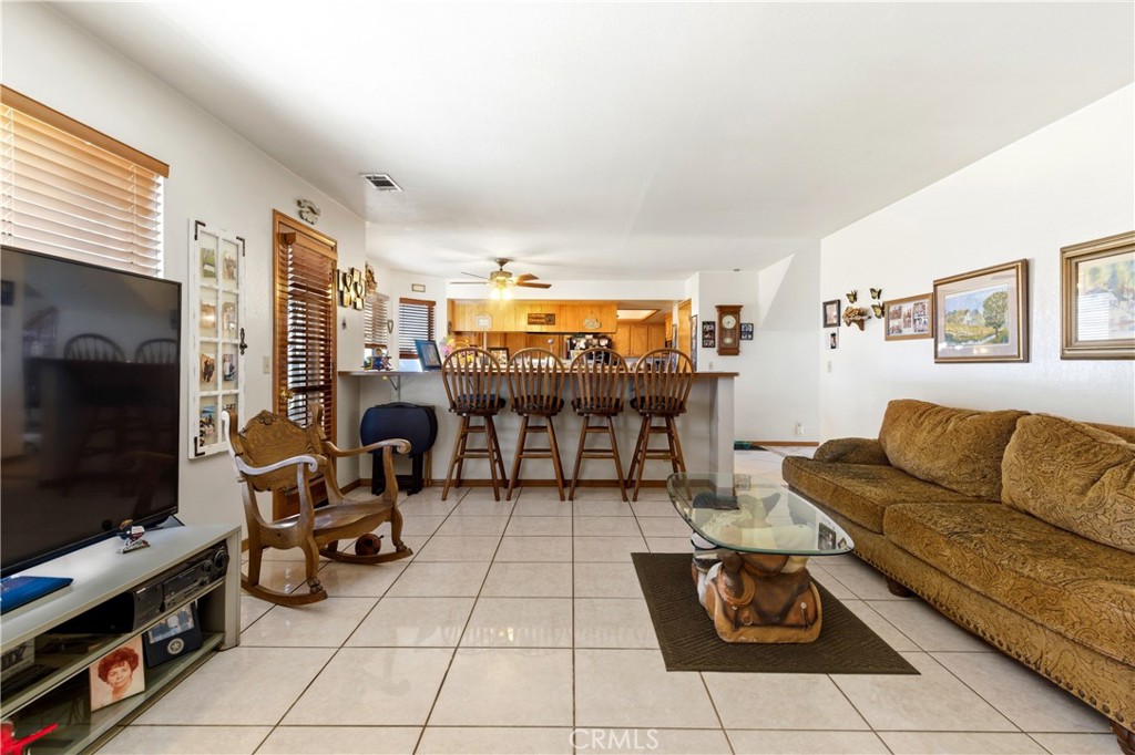 11468 Kiowa Road Apple Valley, CA 92308 - Photo 34 of 73 a living room with furniture and a flat screen tv