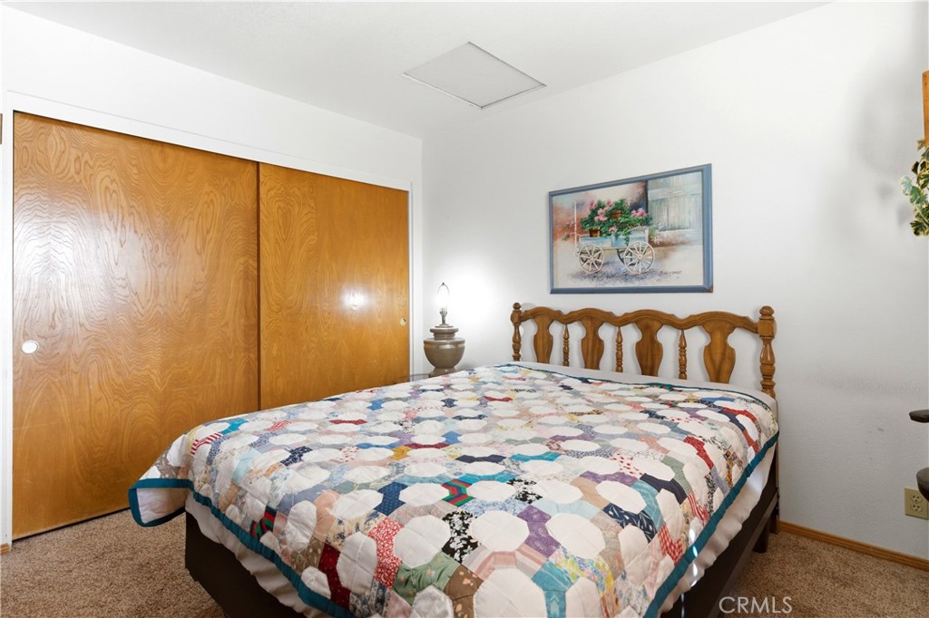 11468 Kiowa Road Apple Valley, CA 92308 - Photo 43 of 73 a bedroom with a bed and painting on the wall