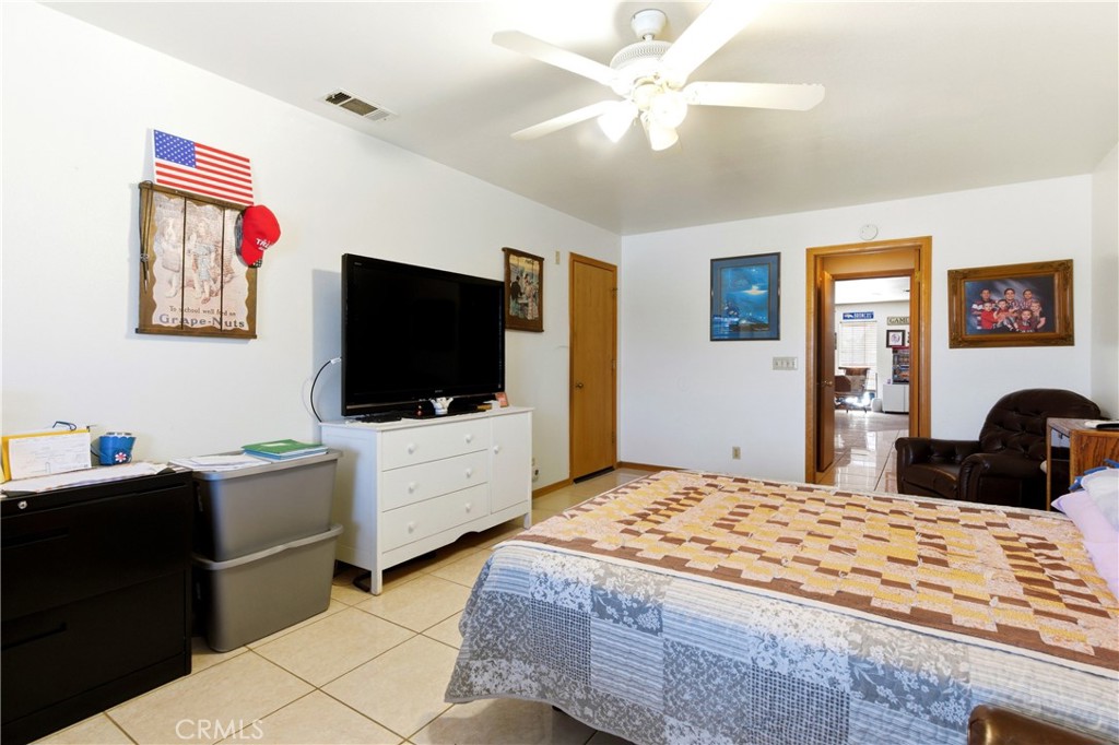 11468 Kiowa Road Apple Valley, CA 92308 - Photo 45 of 73 a bedroom with a bed and a flat screen tv