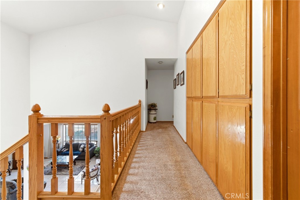 11468 Kiowa Road Apple Valley, CA 92308 - Photo 48 of 73 a view of a hallway with wooden floor and staircase