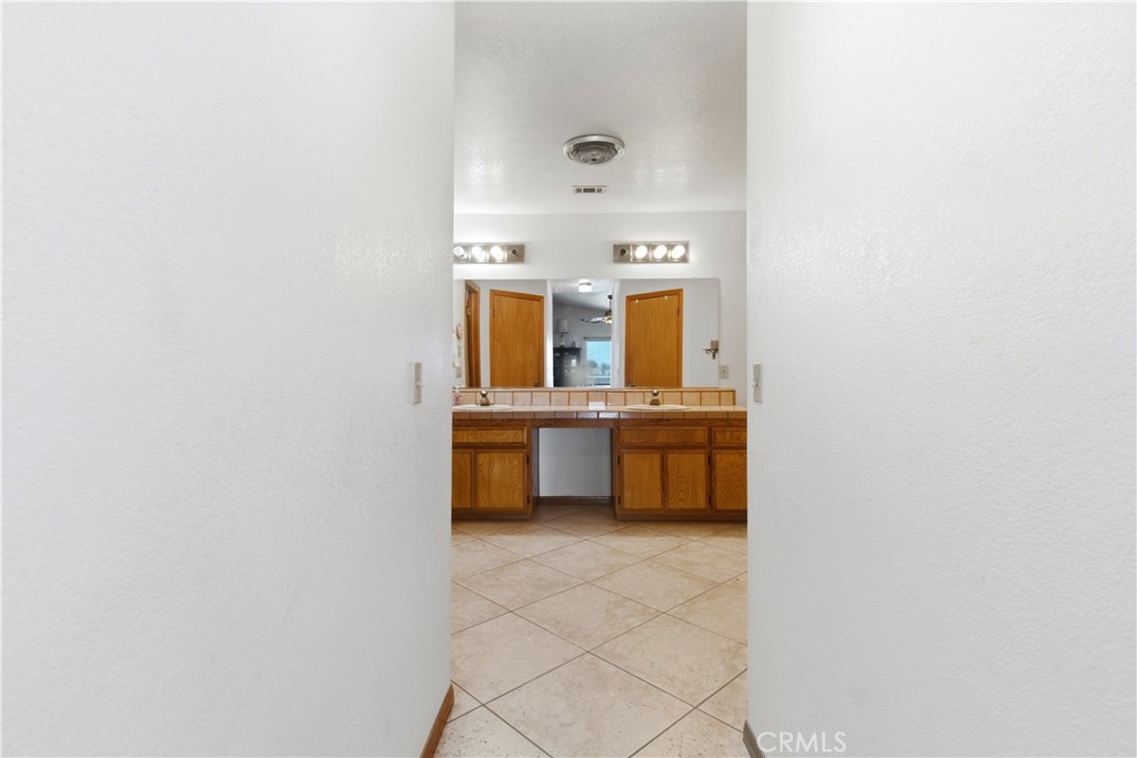 11468 Kiowa Road Apple Valley, CA 92308 - Photo 54 of 73 a bathroom with a sink double vanity and a mirror