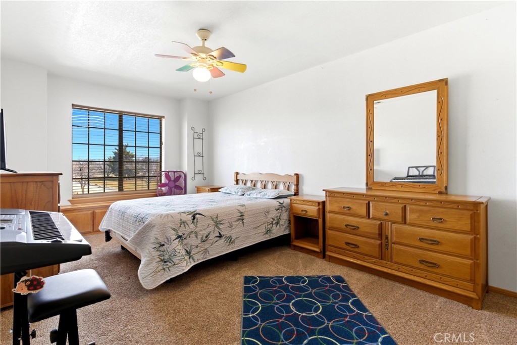 11468 Kiowa Road Apple Valley, CA 92308 - Photo 57 of 73 a bedroom with a bed and a dresser in it