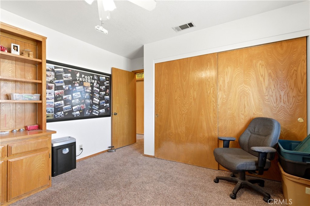 11468 Kiowa Road Apple Valley, CA 92308 - Photo 62 of 73 a view of a workspace with furniture and a window
