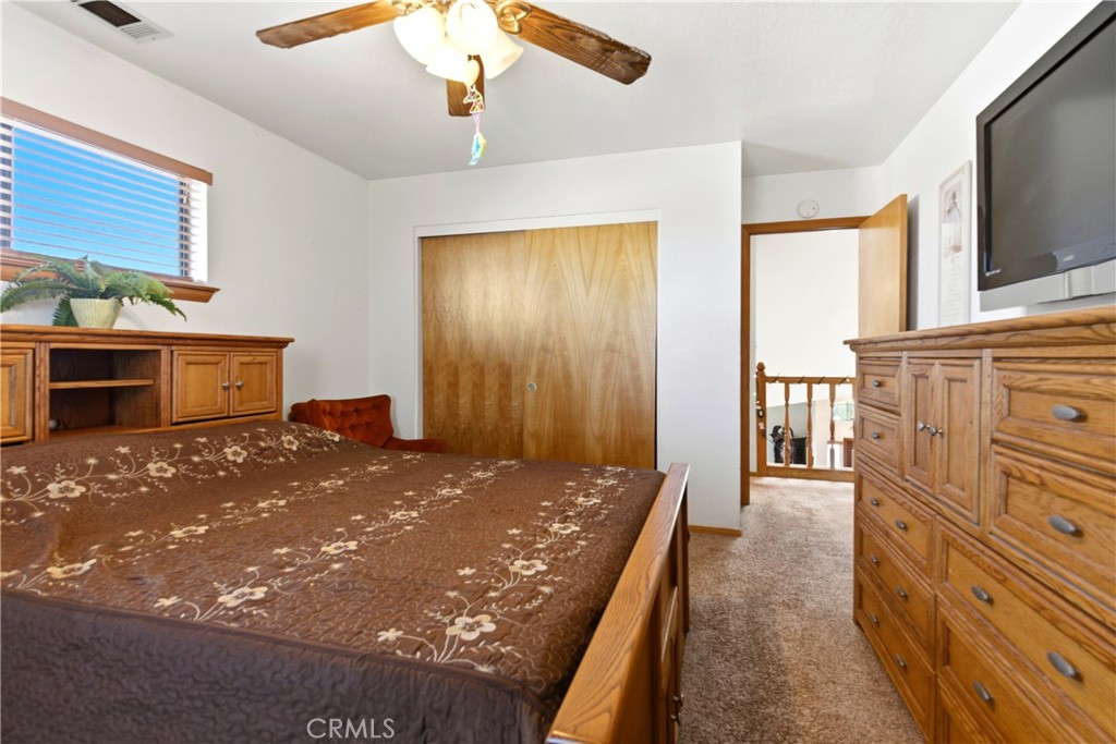 11468 Kiowa Road Apple Valley, CA 92308 - Photo 64 of 73 a bedroom with a bed and a flat screen tv