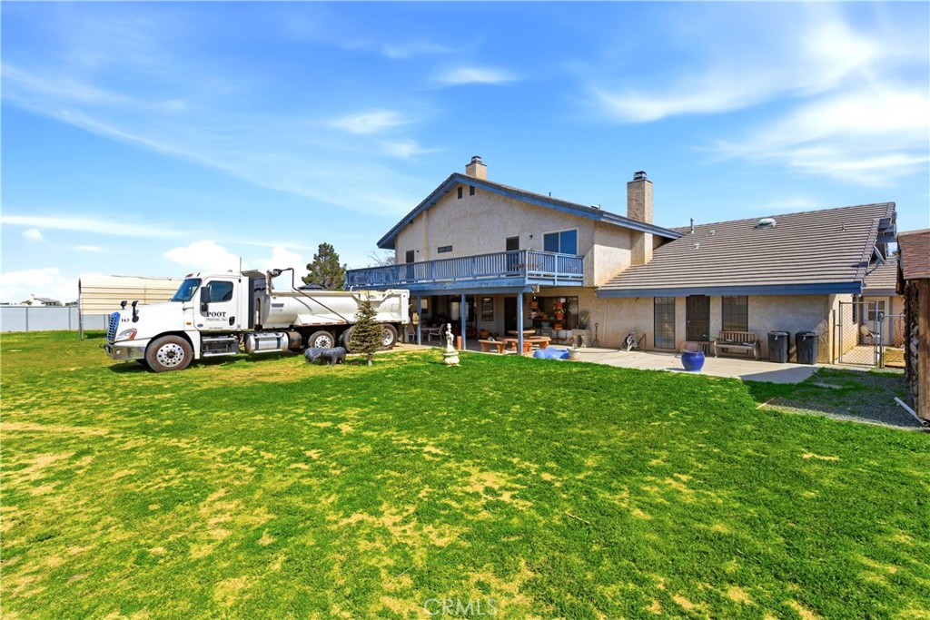 11468 Kiowa Road Apple Valley, CA 92308 - Photo 69 of 73 a front view of a house with a garden and plants