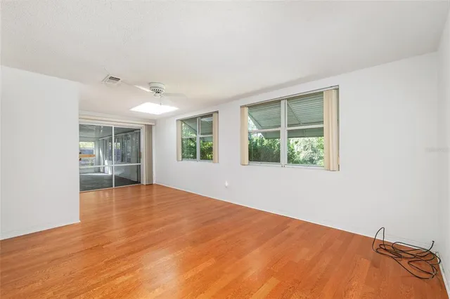 a dining room with a table chairs and a kitchen view