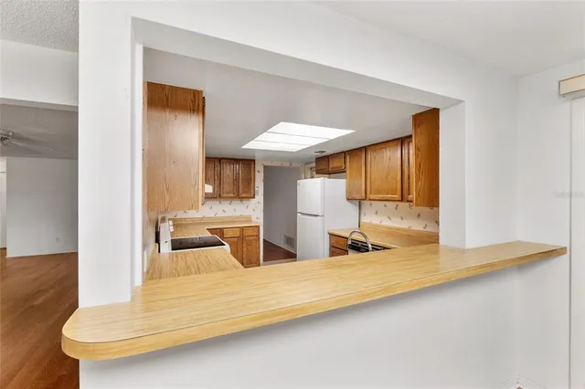 a kitchen with a sink cabinets stainless steel appliances and a counter space