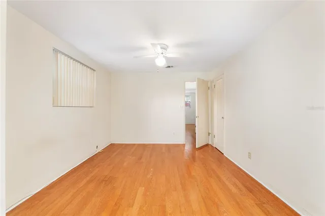 a view of a livingroom with gym equipment and a large window