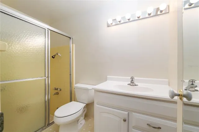 a living room with furniture large window and wooden floor