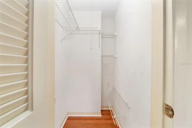 an empty room with a window and wooden floor